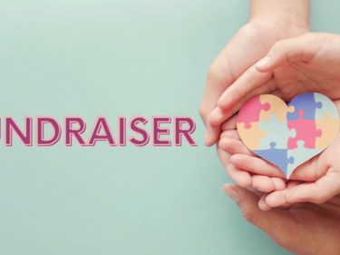 Fundraiser words with 2 hands holding a puzzle heart