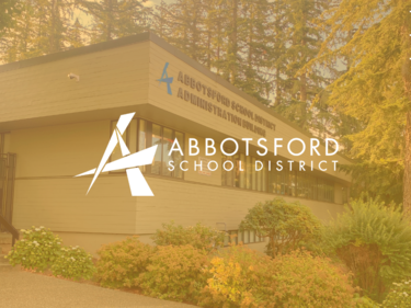 Abbotsford School Board Office with gold overlay and logo in the middle of image