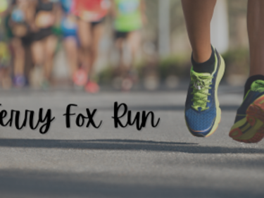 persons shoes moving with a Terry Fox sign