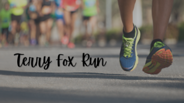 persons shoes moving with a Terry Fox sign