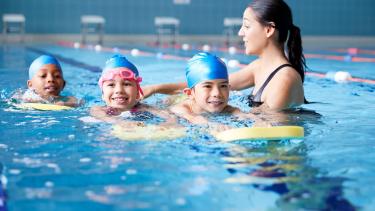 children swimming with an instructor