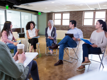 people sitting on chairs in a meeting